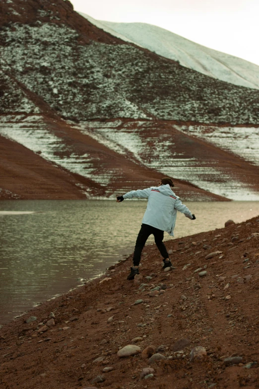 a person in a jacket is throwing a frisbee