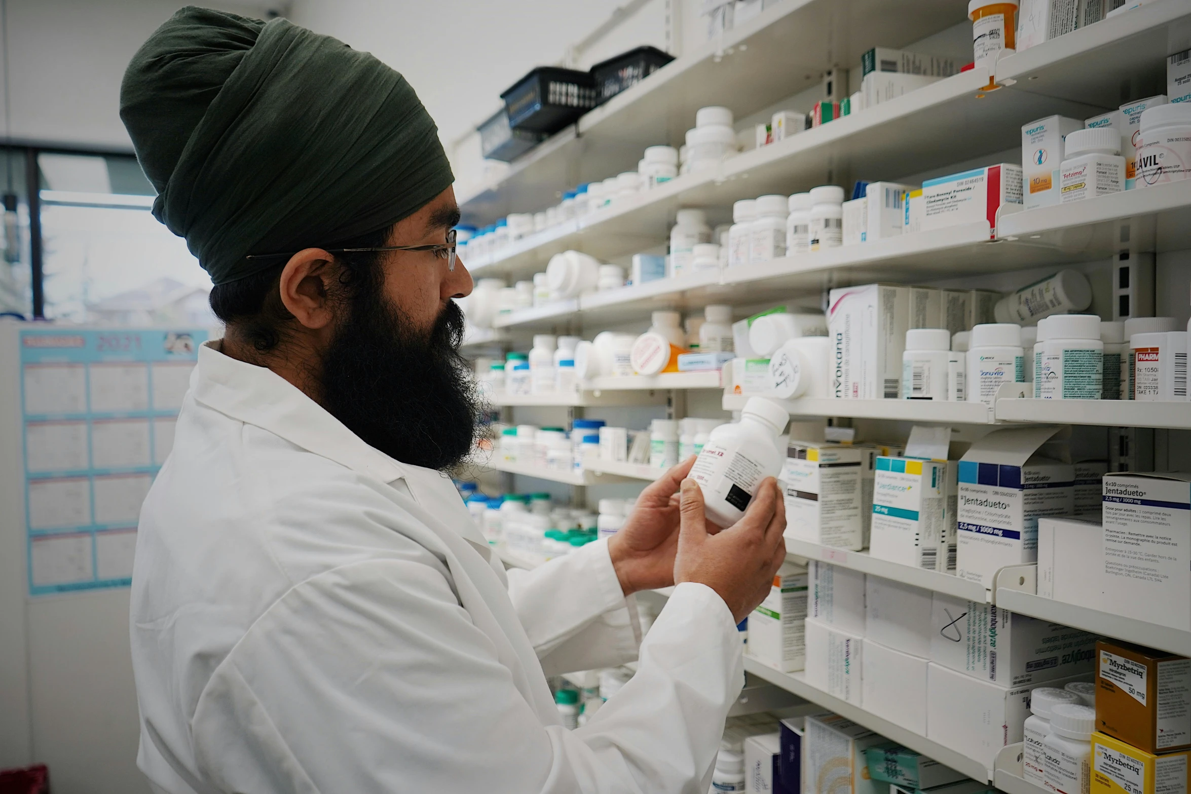 a man with glasses and a beard in a pharmacy store