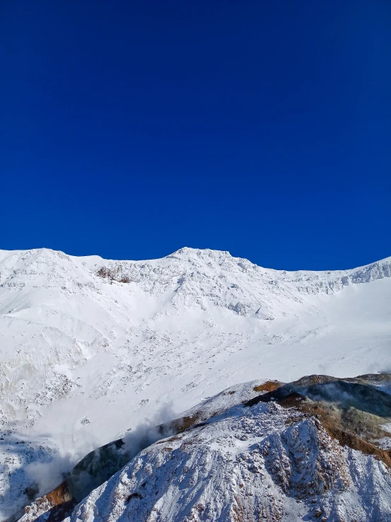 snow covered mountains against a blue sky on a clear day