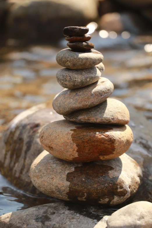 stones piled in the shape of a tower on a rock beach