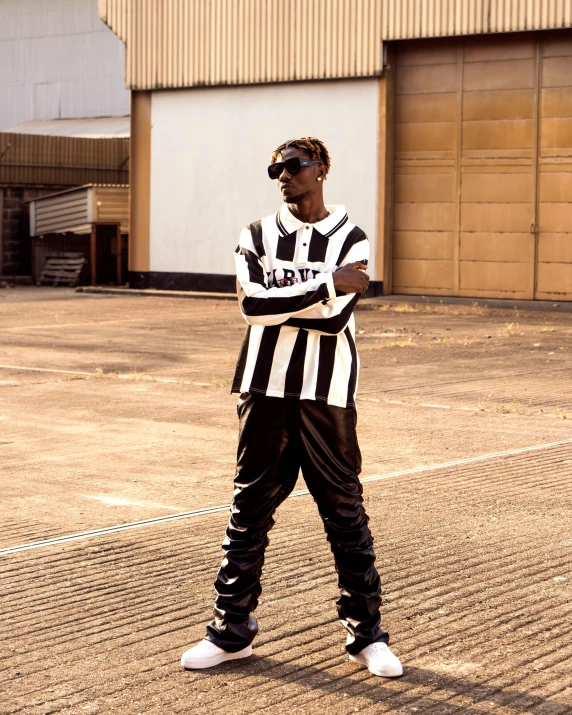 man standing outside wearing soccer uniform and sunglasses