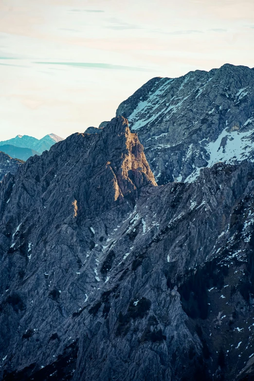 a group of mountains covered in snow under a blue sky