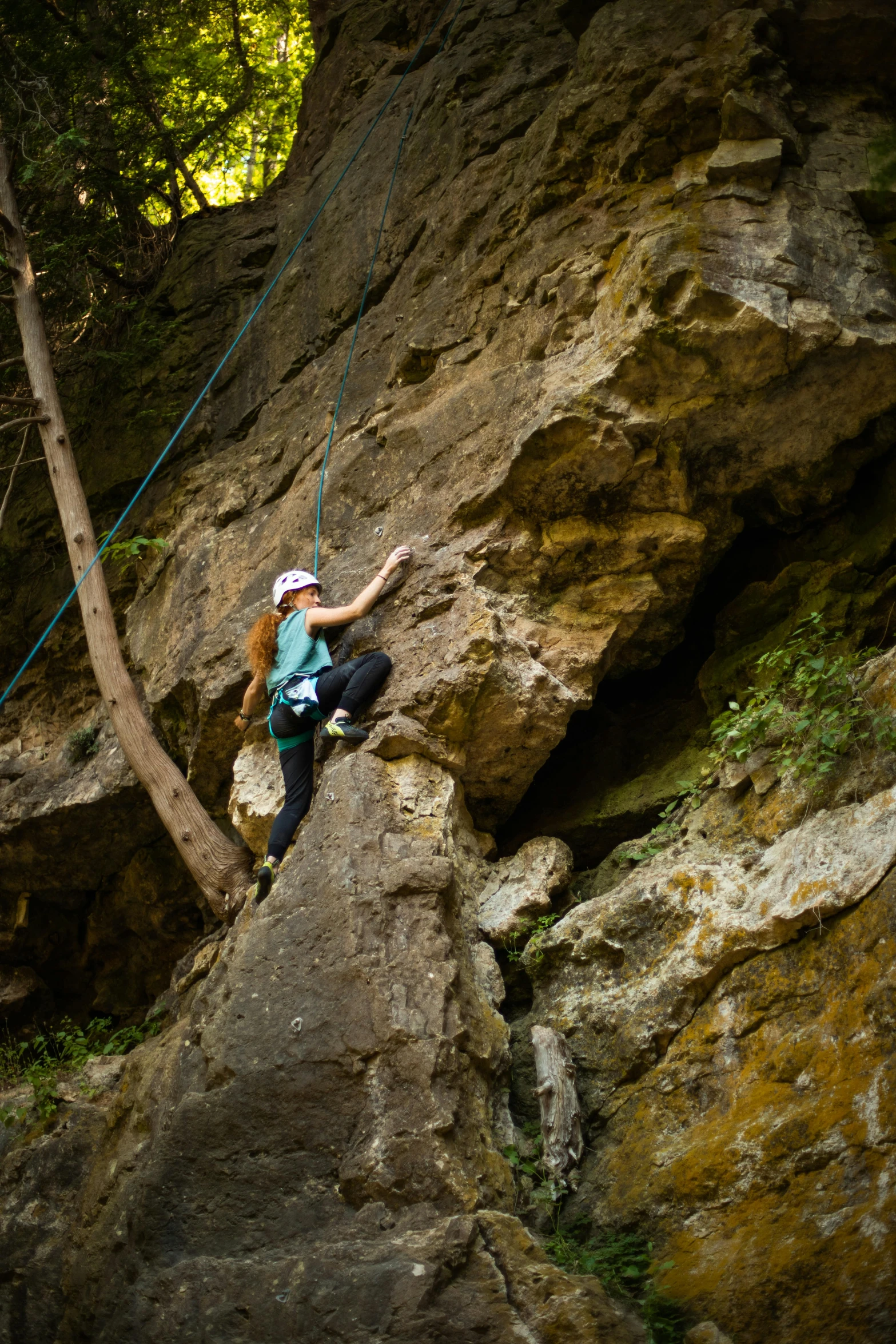 a person climbing up the side of a large mountain