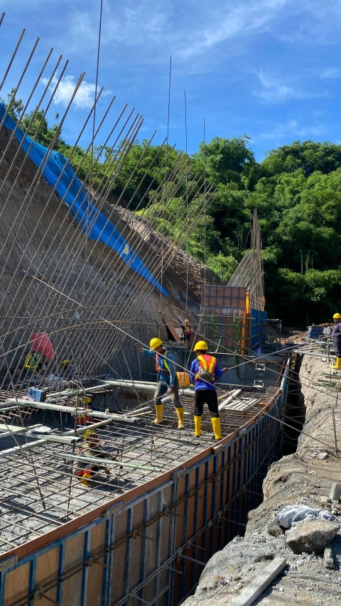 several workers are looking at a building site