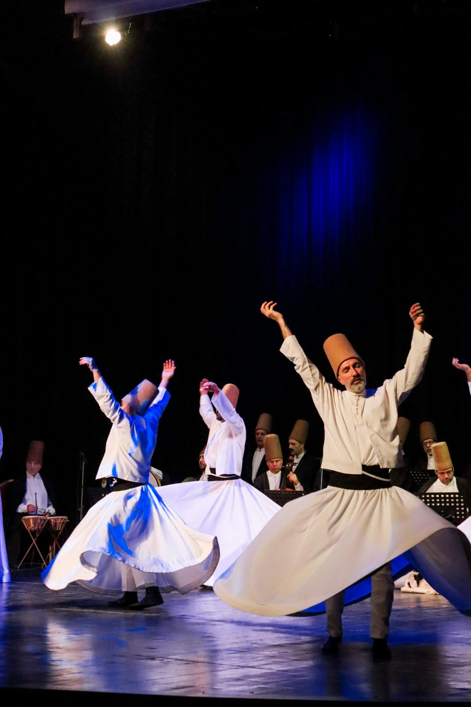 a man and two women performing a folk dance