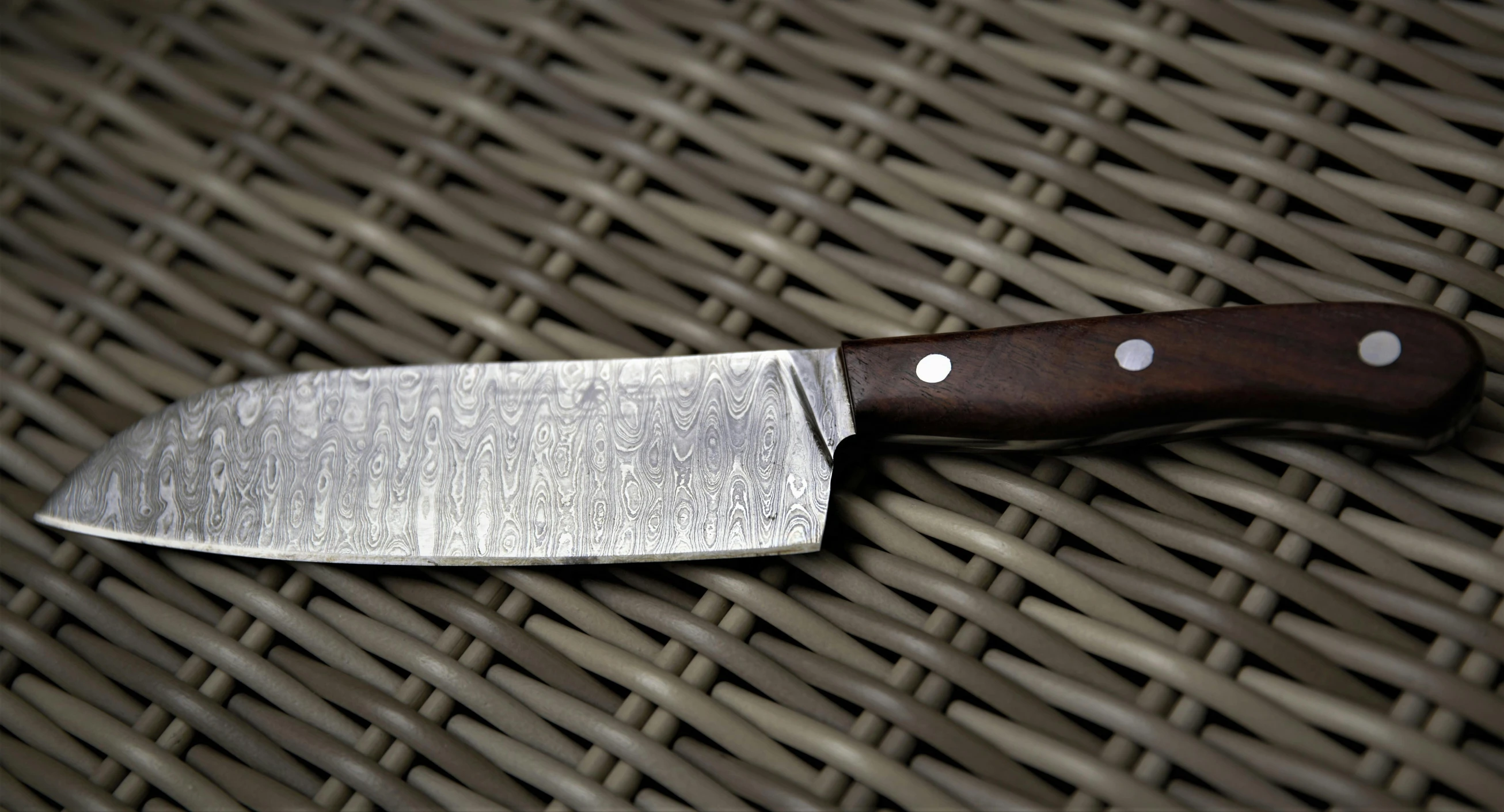 a knife that is on some brown woven