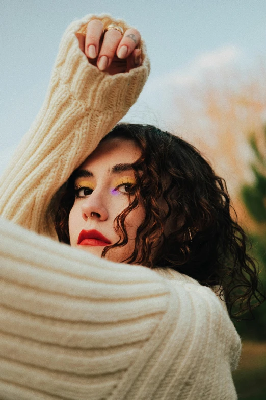 the woman is posing with her arms around her head