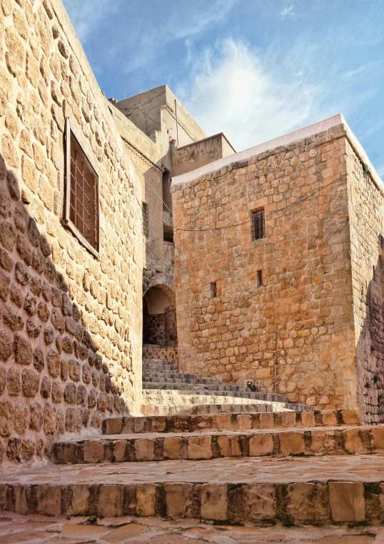 a stone wall with a brick stair case