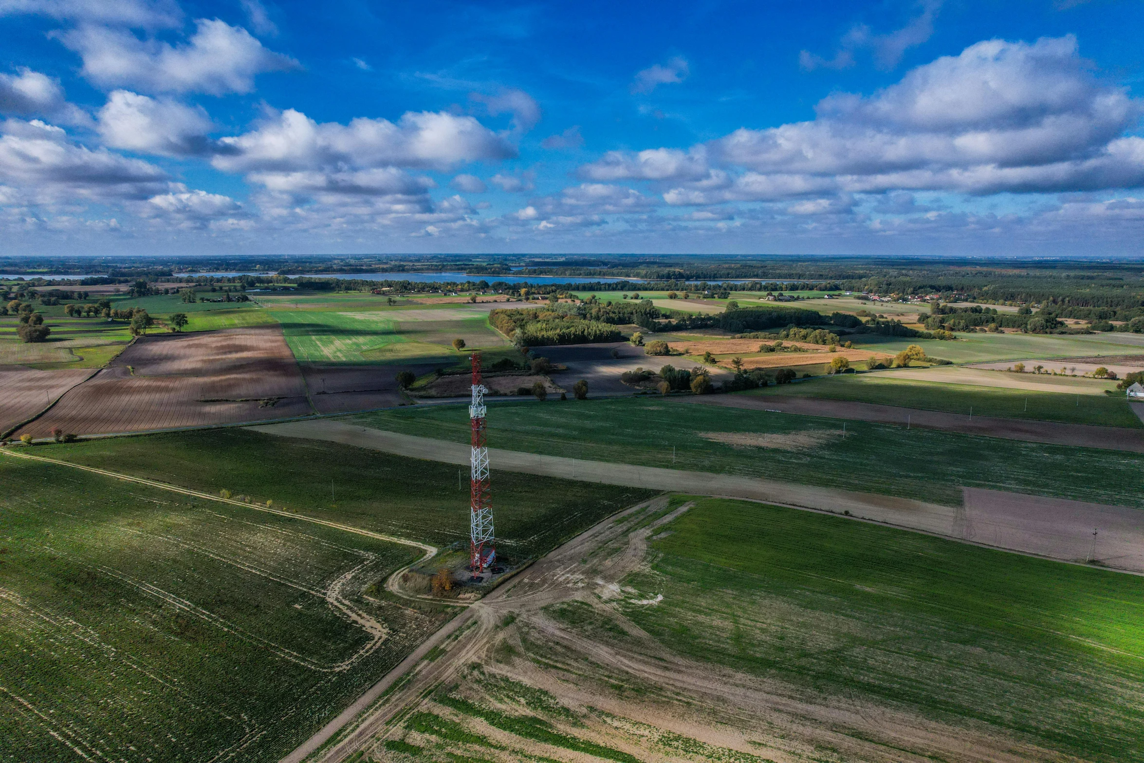 an aerial s of fields and towers on a sunny day