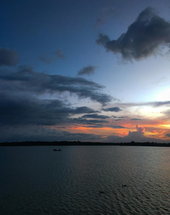 the clouds are very dark and fluffy at sunset