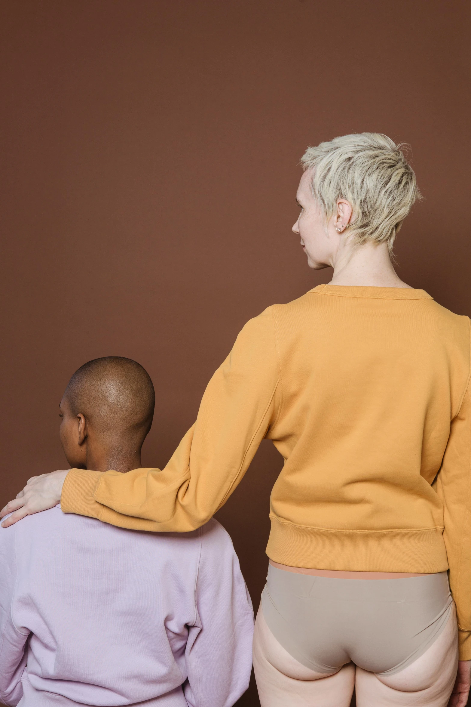 a man and woman standing beside each other in underwear