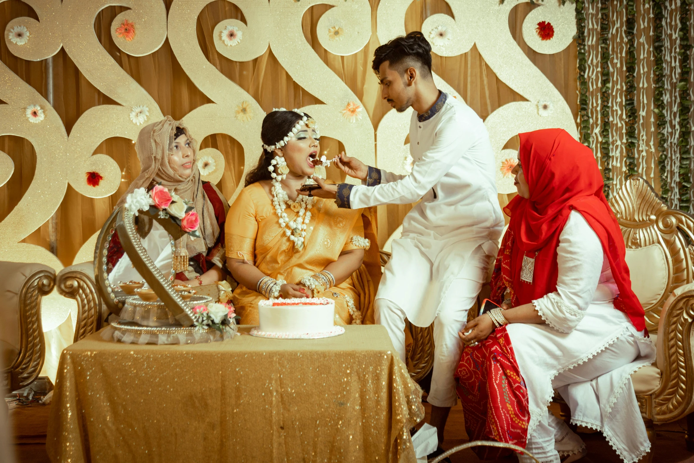 an indian bride and groom  the cake at their wedding reception