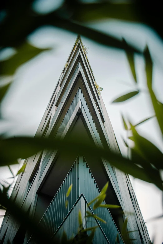 some type of triangular building with several windows