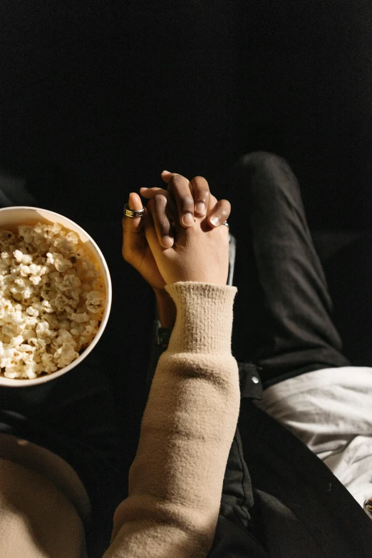 a man is eating soing with his hand