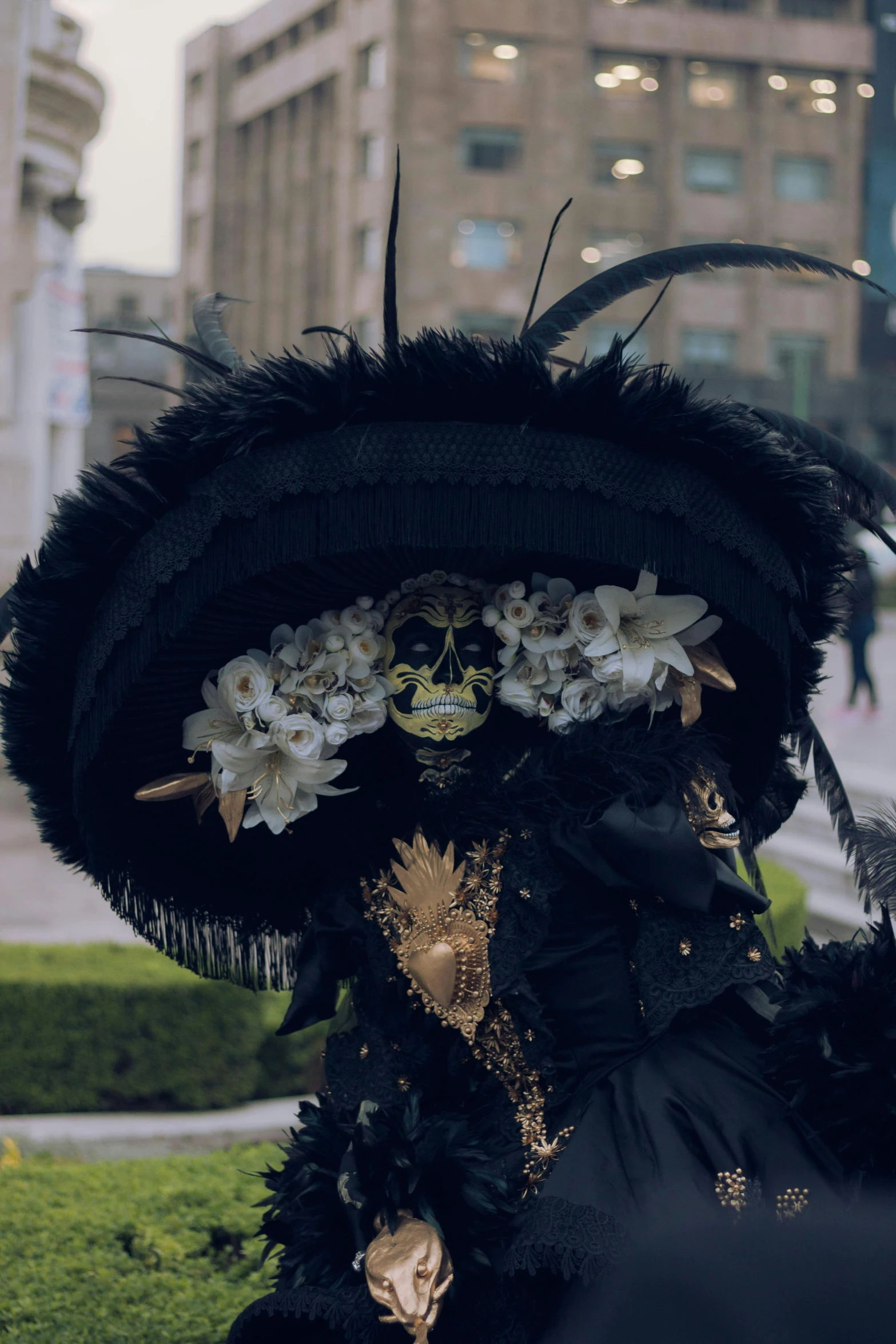 a woman wearing a mask and feathers on her face