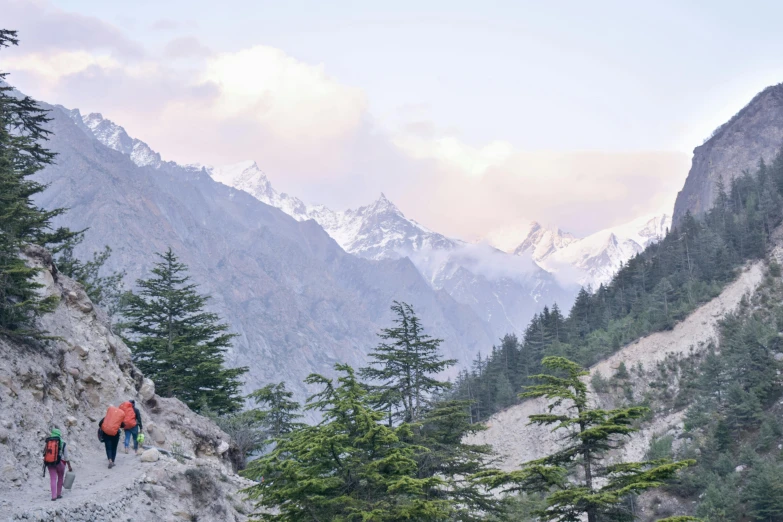 people are hiking up a steep mountain trail