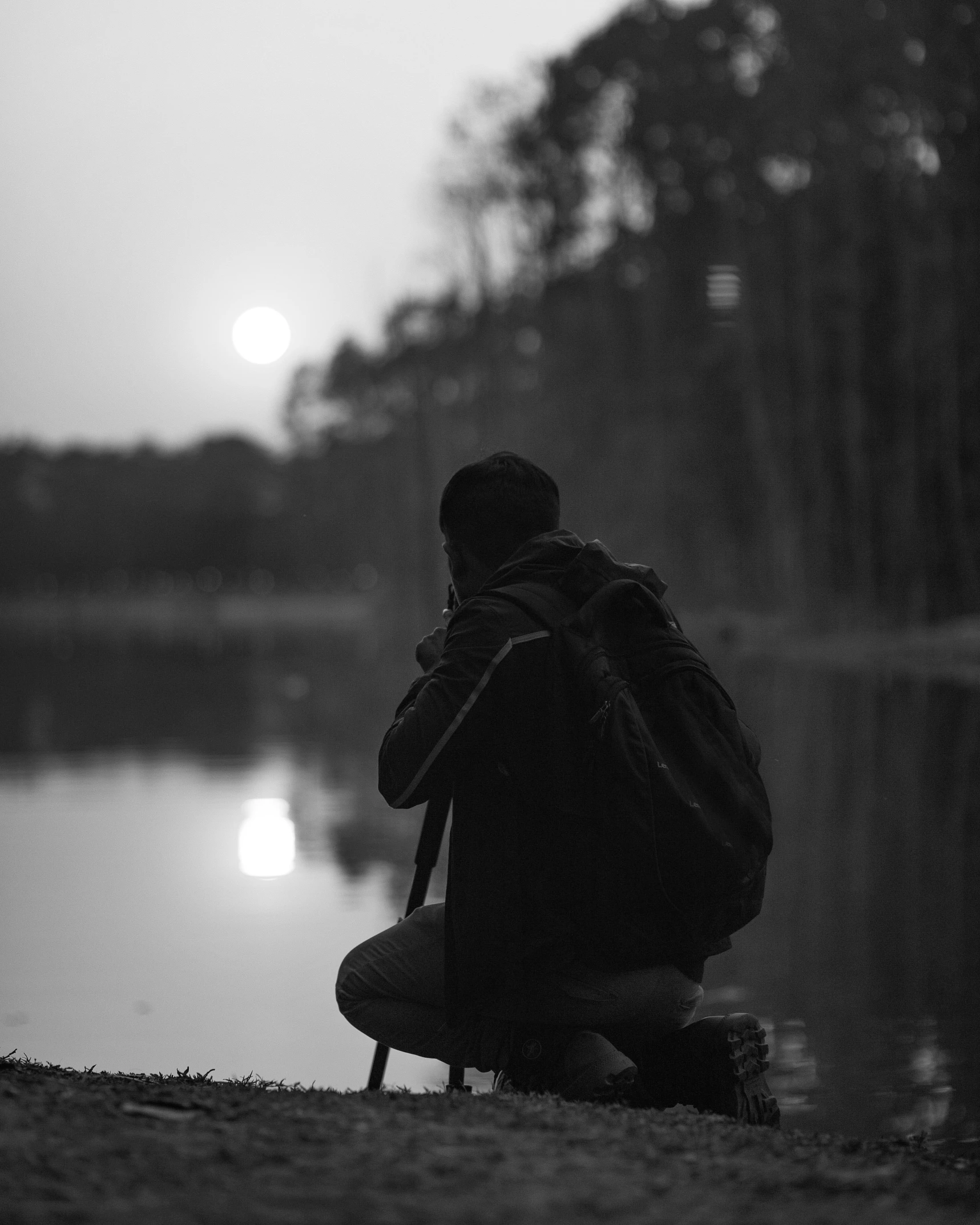 person sitting on the ground taking a picture