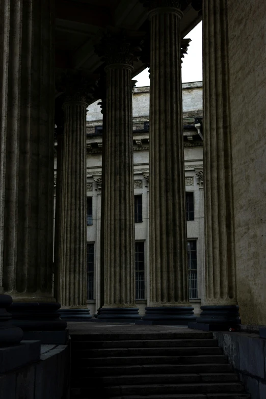 the stairway is lined with stone columns and pillars