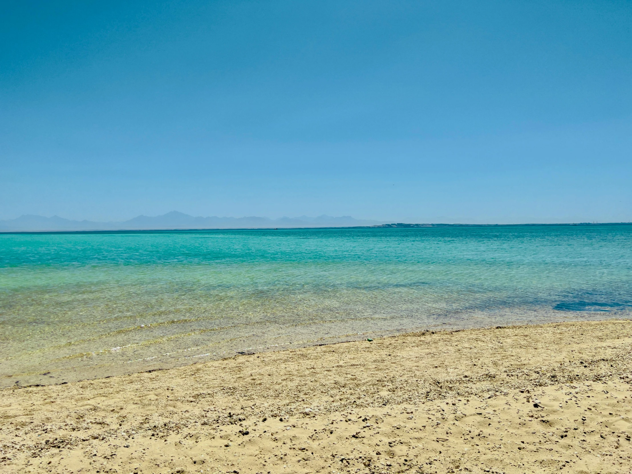 the view from a sandy beach with no people on it