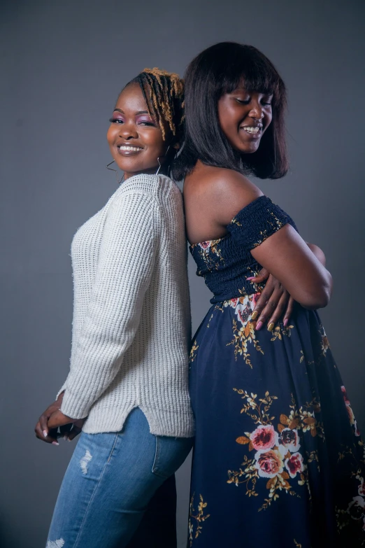 two women standing close to one another smiling