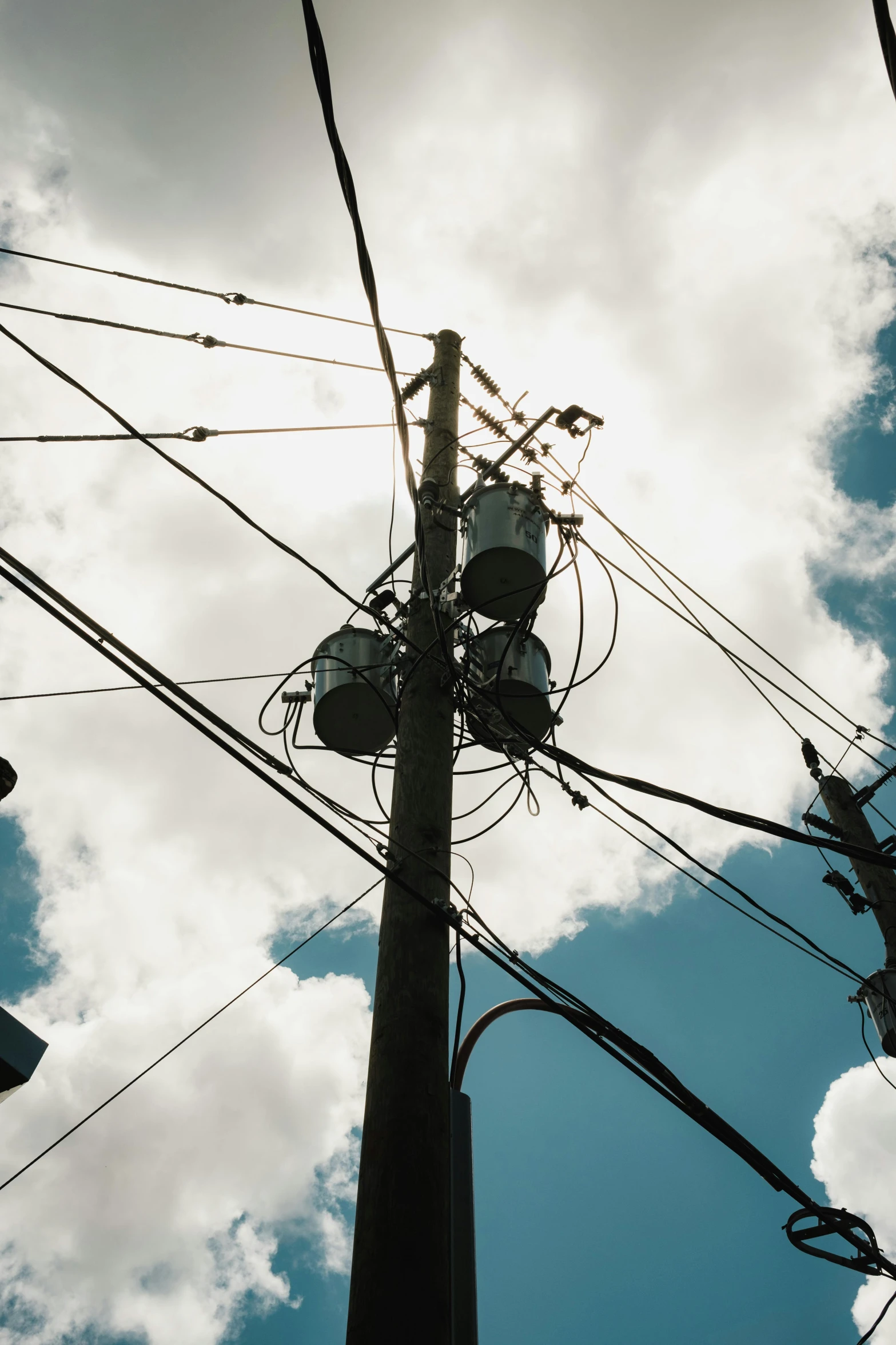 power lines and wires in the air under cloudy sky