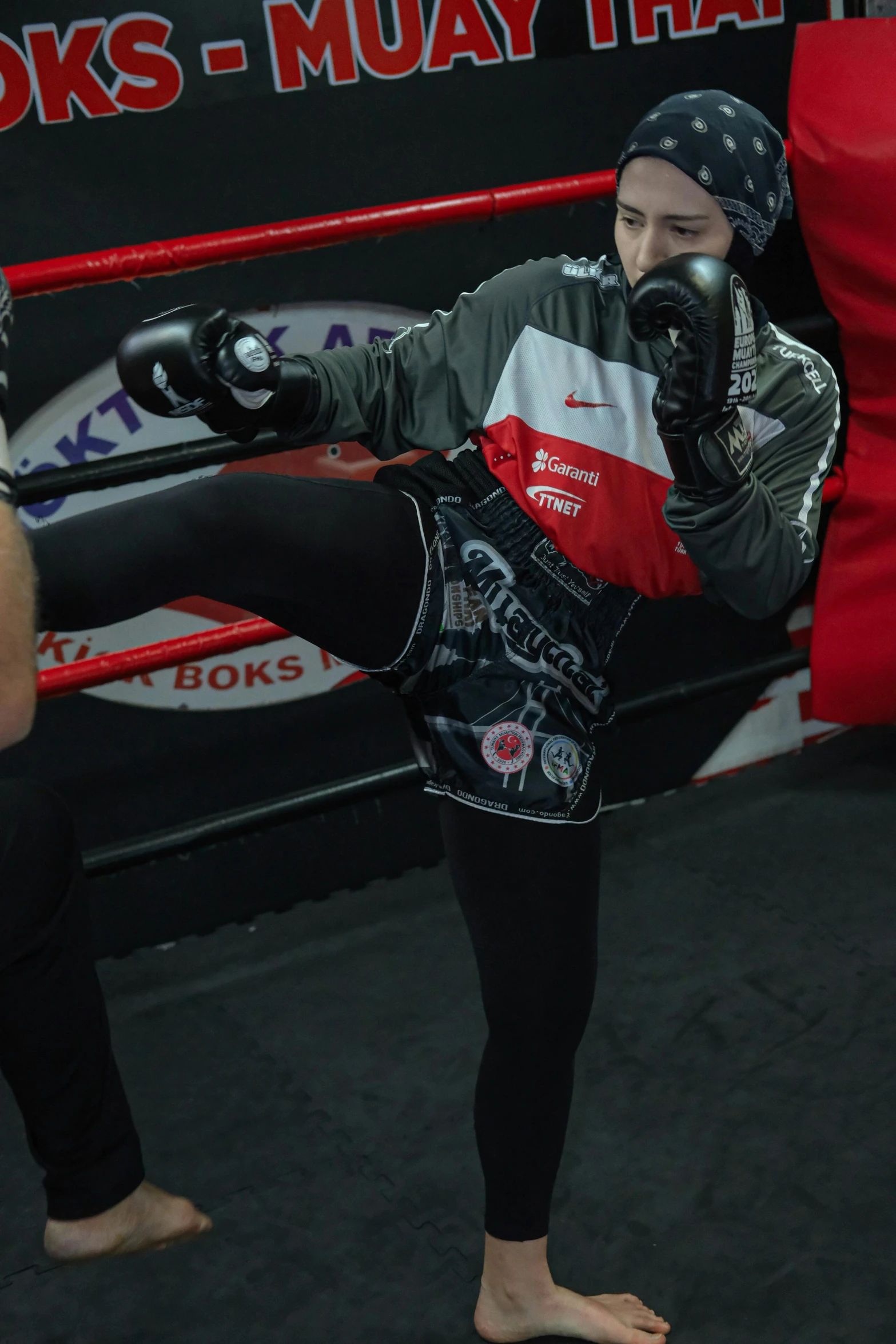 a man standing next to a boxing ring