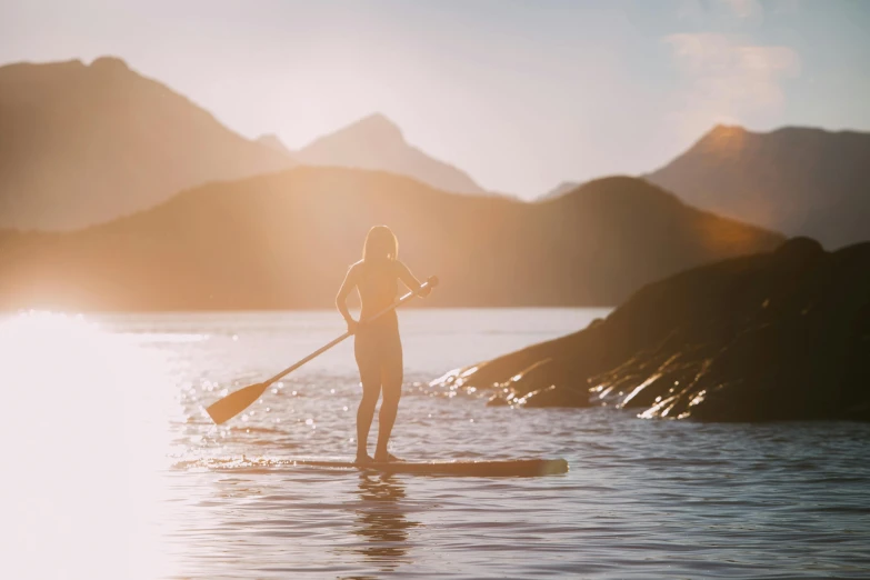 a person on a paddle board in the water