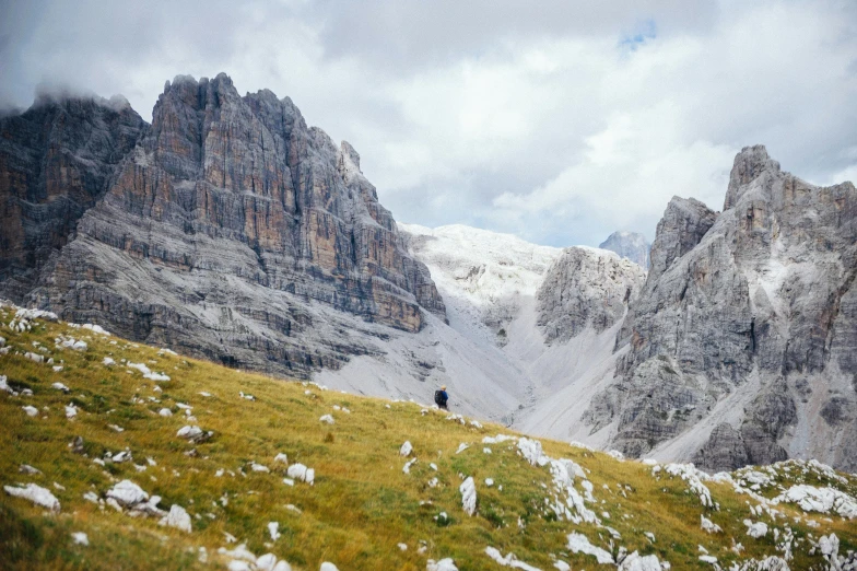 the person on the mountain is standing with a cellphone