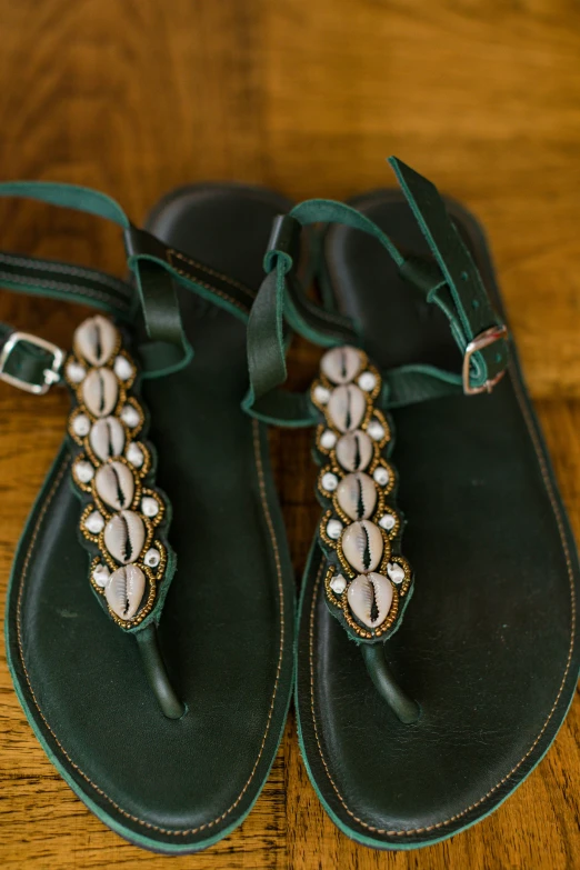 shoes and green leather handbag on wooden table