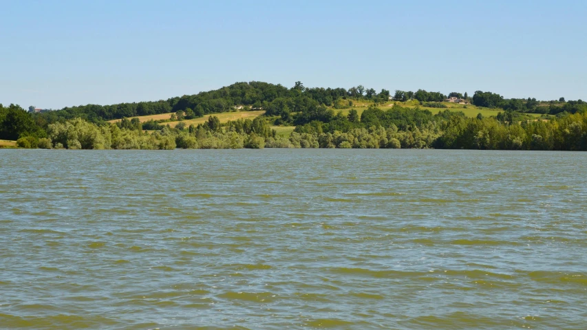 a lake in front of a mountain and a small island