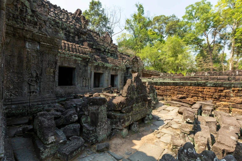 a very old building with big stones and trees