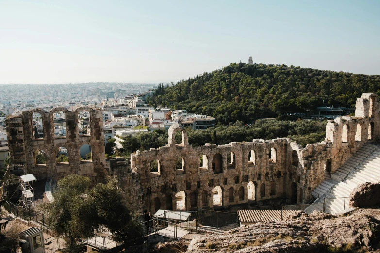 the ruins of an old building stand out over a large valley