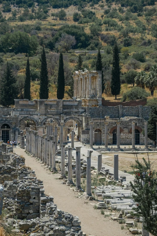 an outdoor ruins of roman architecture with trees in the background