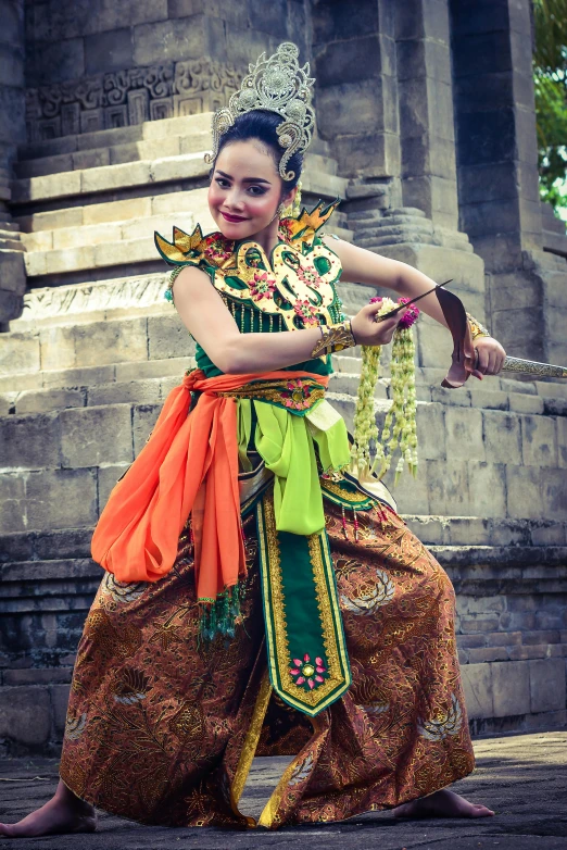 a beautiful young woman dressed in an indian costume