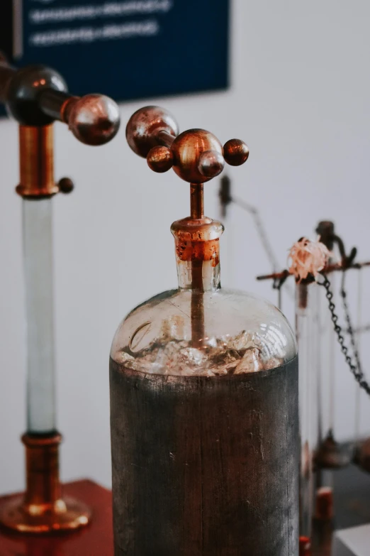 two bronze colored vessels on top of a wooden table