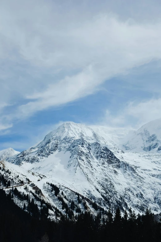 there is a snow covered mountain range against a blue sky