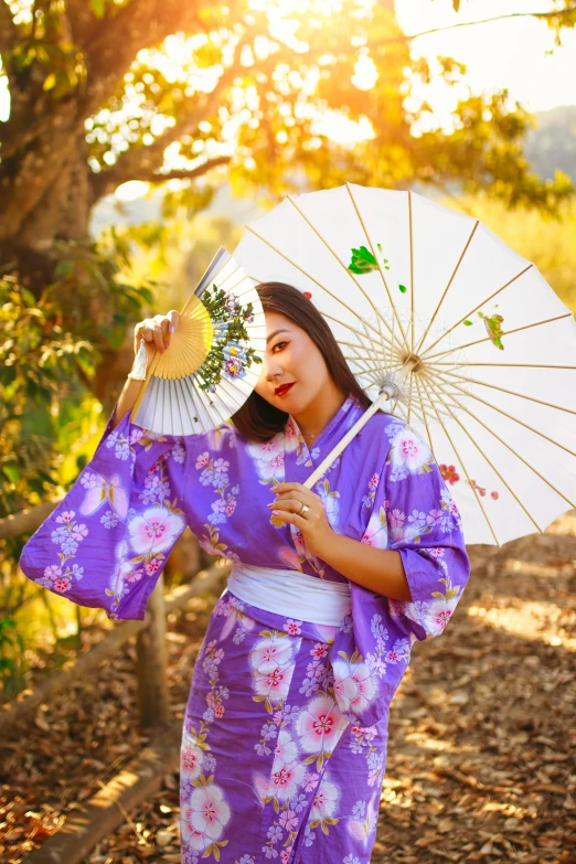 the woman has a fan and is posing for a picture