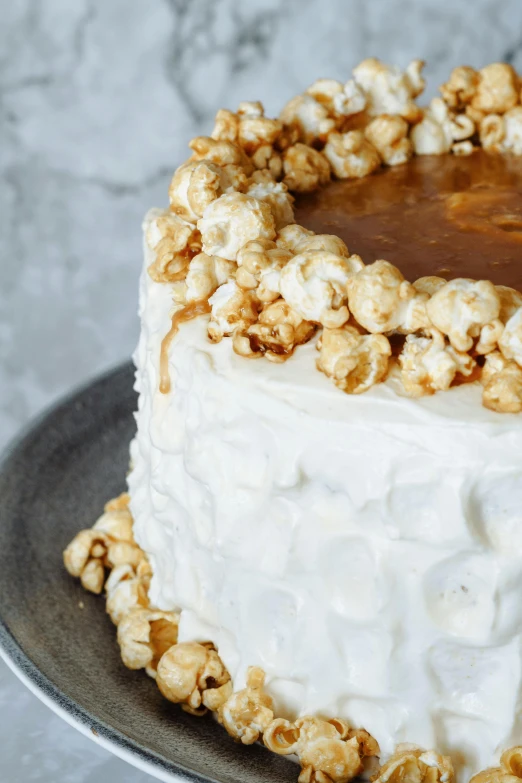 a frosted cake with walnuts on top