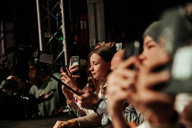 a group of people taking pictures in front of a crowd