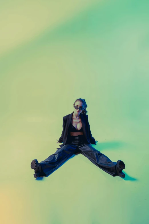 a woman sitting on the ground wearing glasses