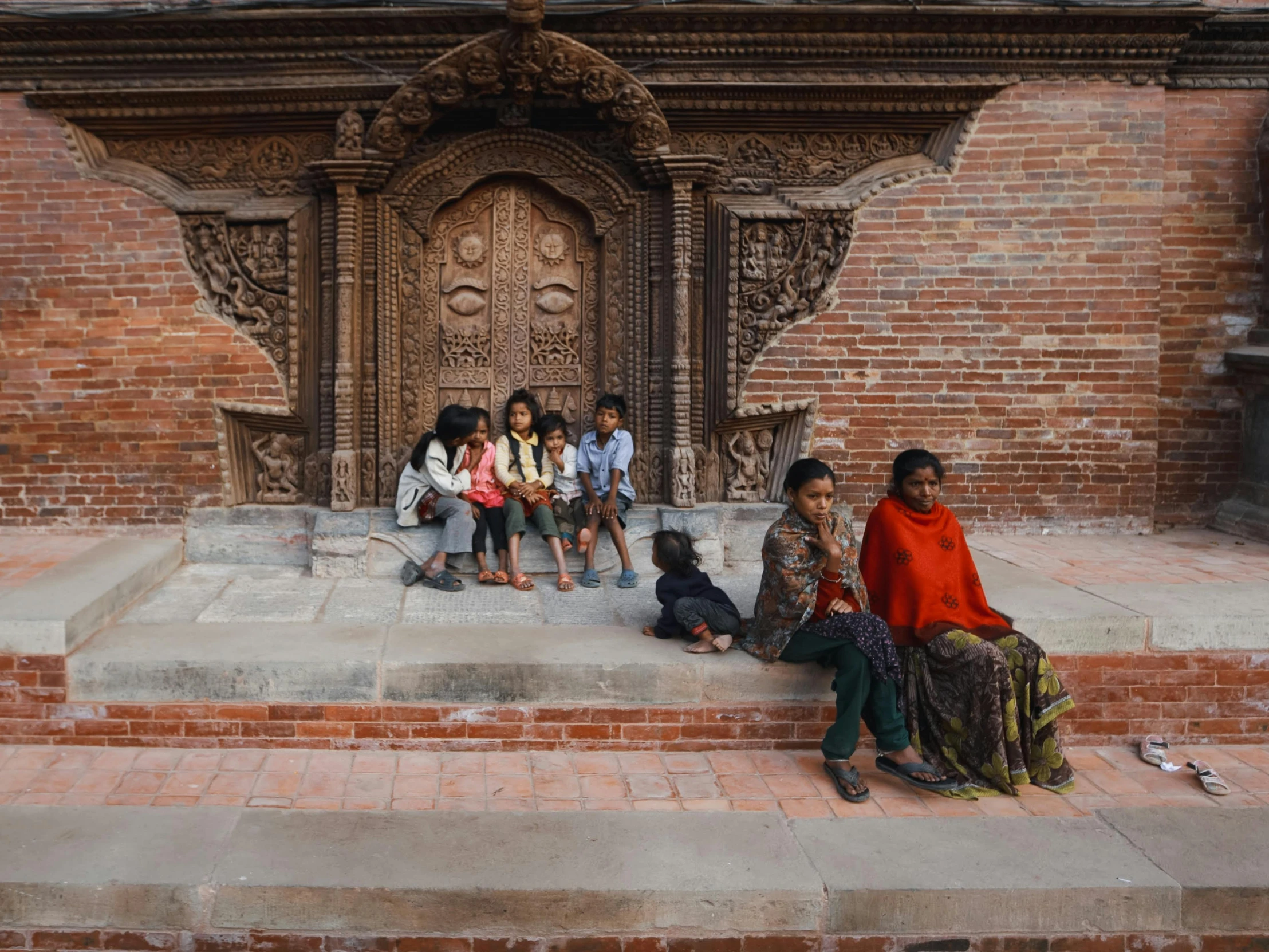 several children sitting at the end of some steps