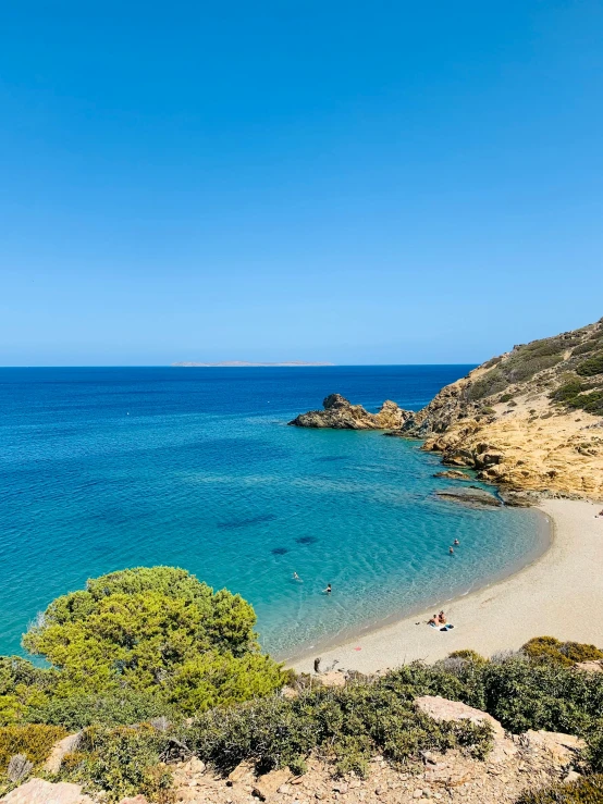 an overhead view of the blue water and beach