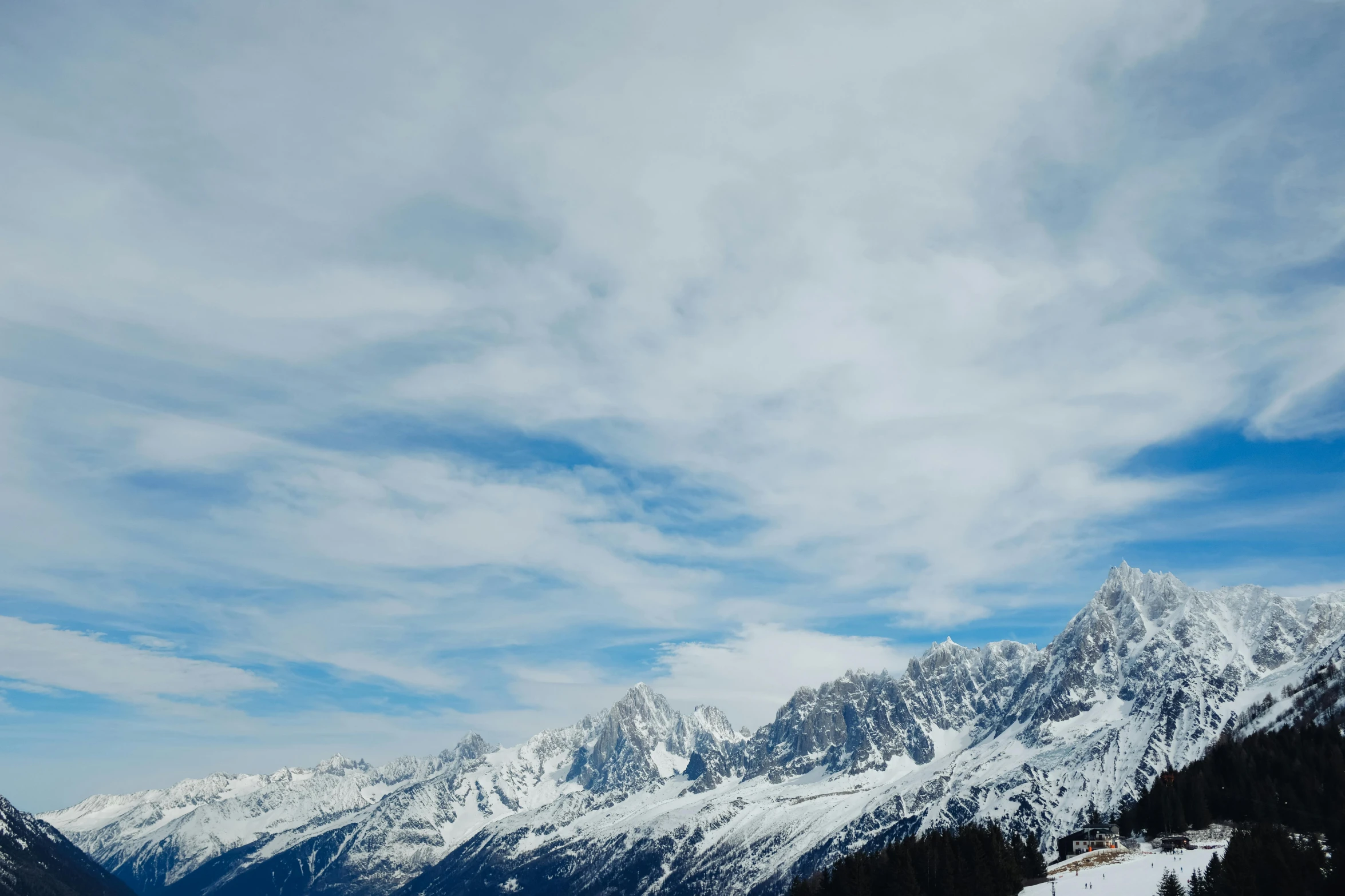 a group of people standing on top of a snow covered slope