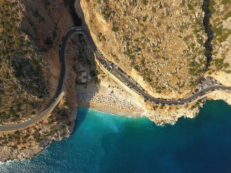 aerial view of winding road by the ocean