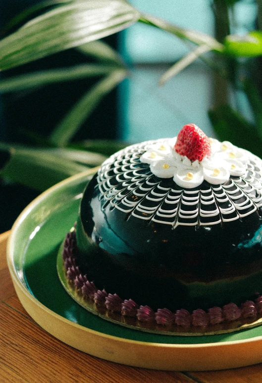 a chocolate cake sits on a green plate