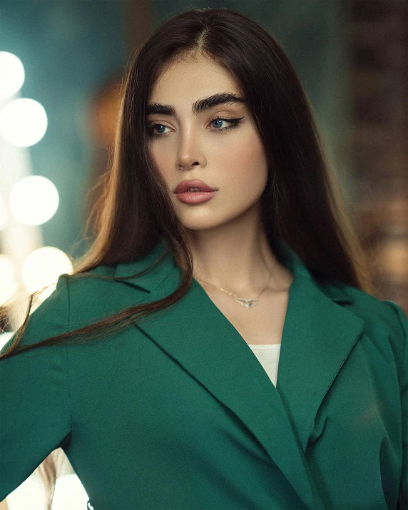 a young woman in green and white posing for a po