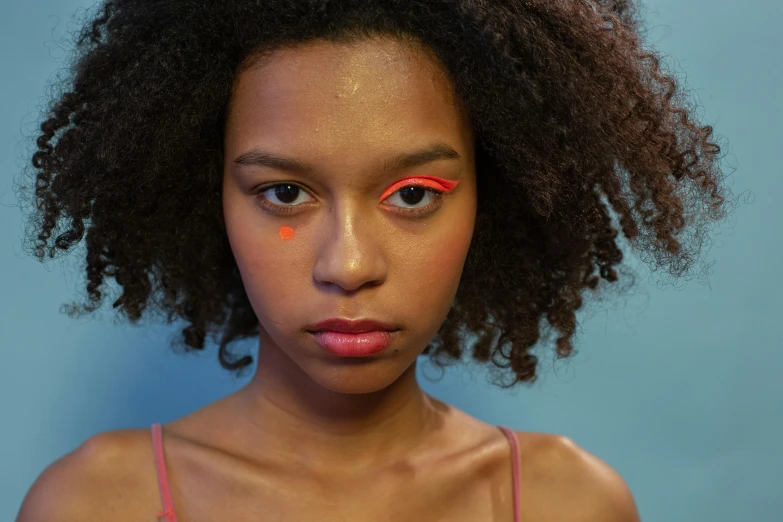 a girl with bright orange paint on her face