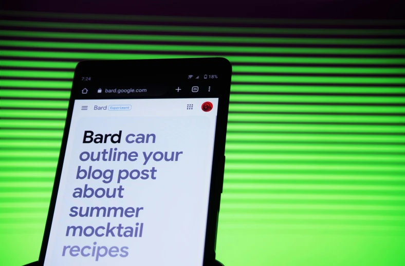 a hand holds up a smart phone displaying the words barc can outline your blog post about summer mocktail recipes