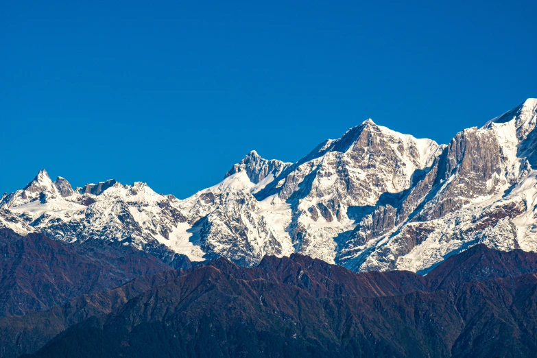 the mountain range of mountains in an extremely dark blue sky