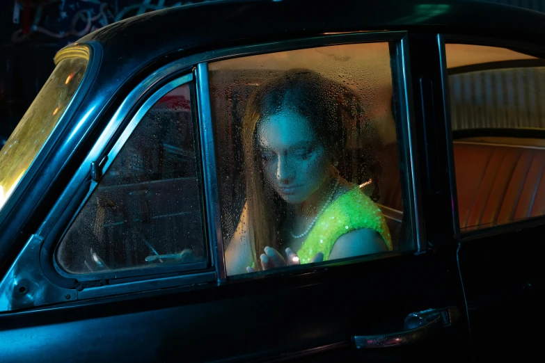 a person looking out of a car window on the street